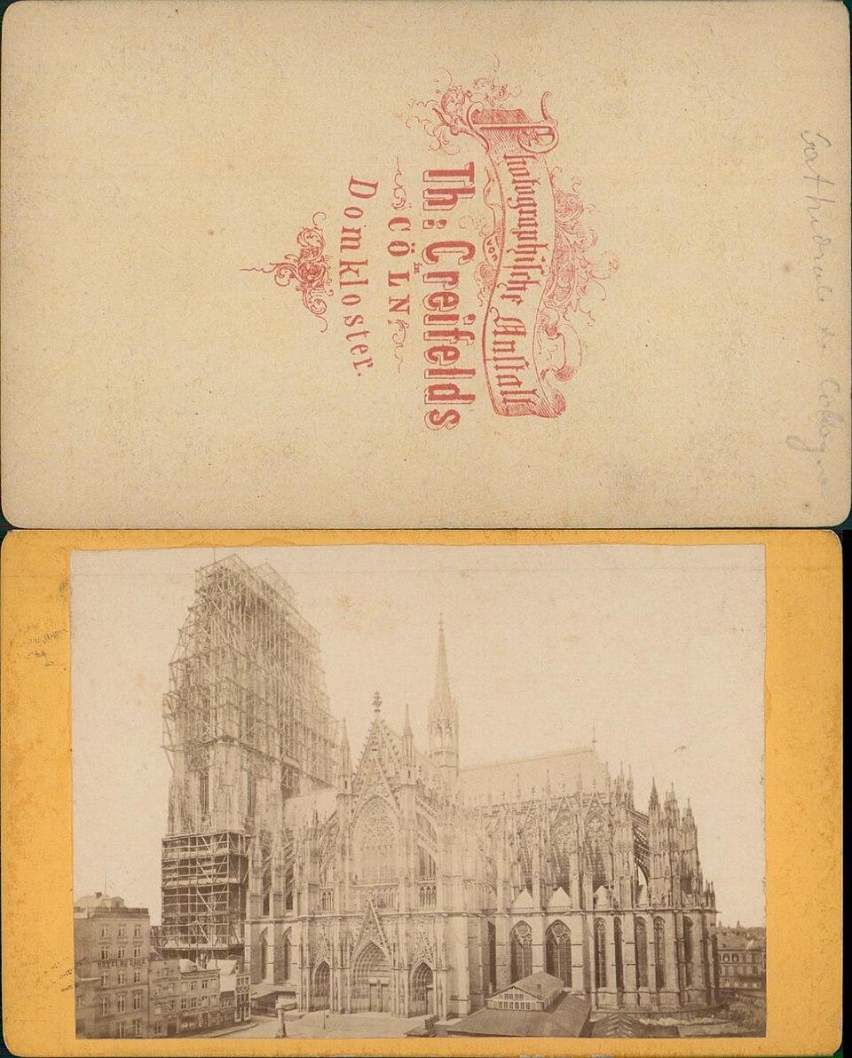 Cologne Cathedral, south side, towers scaffolded, ca. 1880. Theodor Creifelds. The card back is lettered Photographische Anstalt Th. Creifelds, Domkloster, Cöln.. Street photograph.